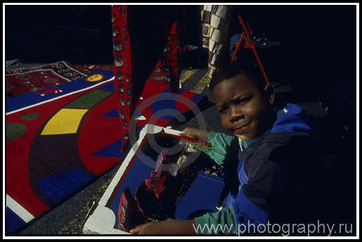 Boy with a mirror, flea-market in Manhattan on Sunday